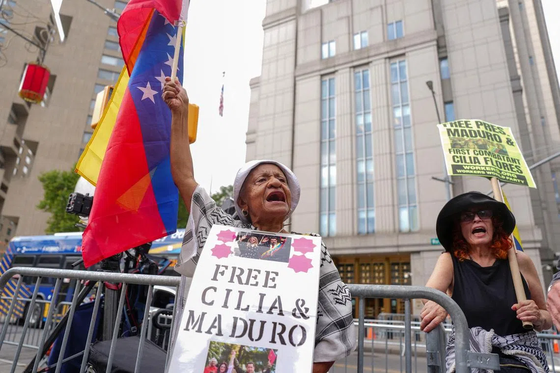 A person holds the Venezuelan flag on the day of the hearing on criminal charges, including narcoterrorism, against ousted Venezuelan president Nicolas Maduro and his wife Cilia Flores at the Daniel Patrick Moynihan United States Courthouse in New York City, U.S., July 22, 2026. REUTERS/Angelina Katsanis