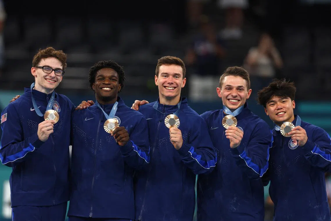 Paris 2024 Olympics - Artistic Gymnastics - Men's Team Victory Ceremony - Bercy Arena, Paris, France - July 29, 2024. Bronze medallist's Stephen Nedoroscik, Paul Juda, Brody Malone, Frederick Richard and Asher Hong of United States celebrate on the podium with their medals. REUTERS/Hannah Mckay