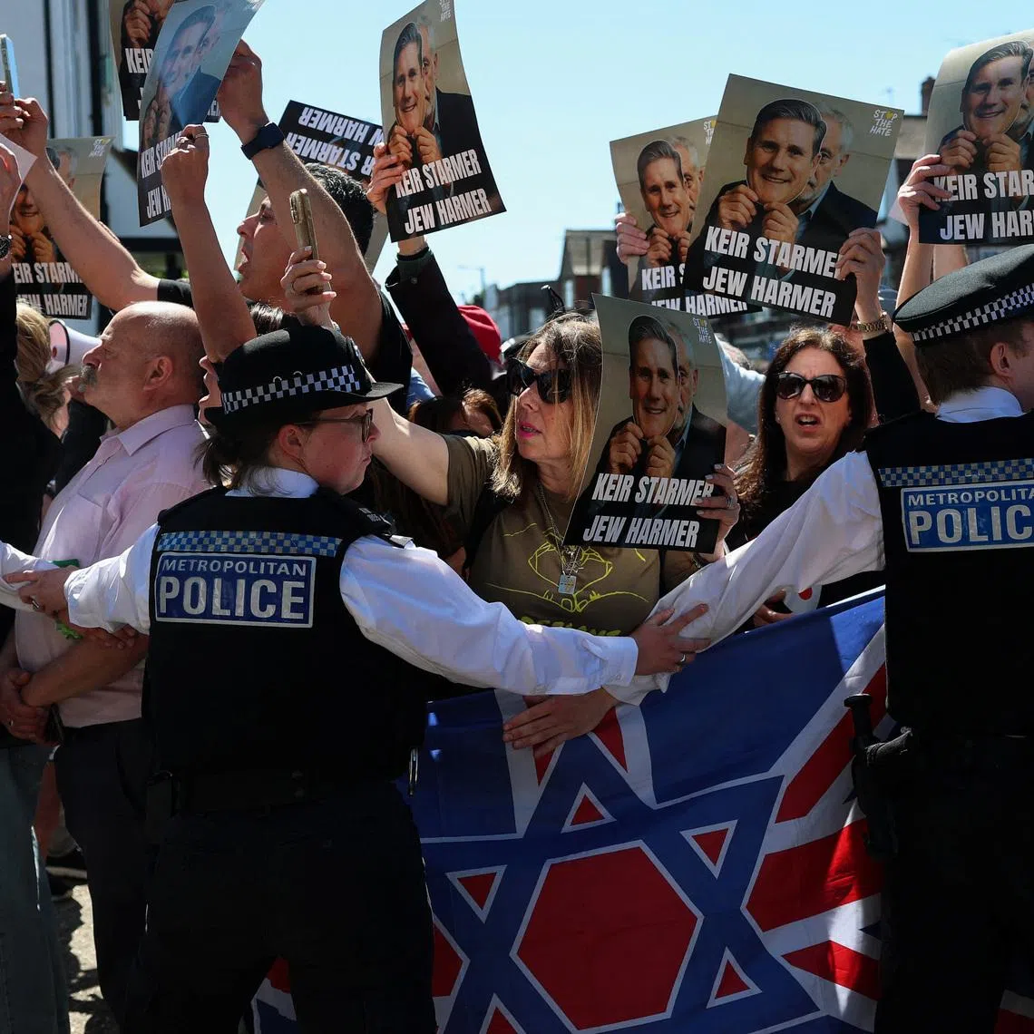 People protest against British Prime Minister Keir Starmer, as he arrives to make a visit to the Golders Green area, which is home to a large Jewish population, after a man was arrested on Wednesday following a stabbing incident in which two Jewish men were wounded, in London, Britain, April 30, 2026. REUTERS/Hannah McKay