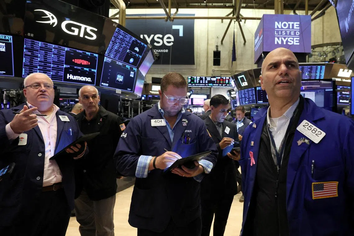 Traders work on the floor of the New York Stock Exchange, in New York City.