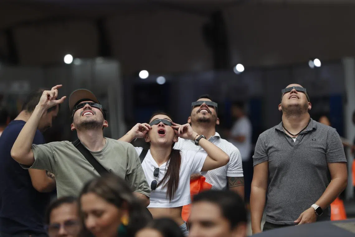 People observing the annular solar eclipse from Cali, Colombia, on Oct 14, 2023. 