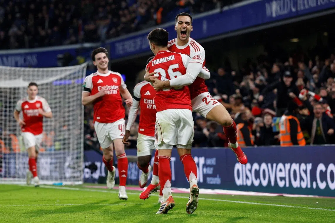 Arsenal's Martin Zubimendi celebrates scoring their third goal with Mikel Merino.