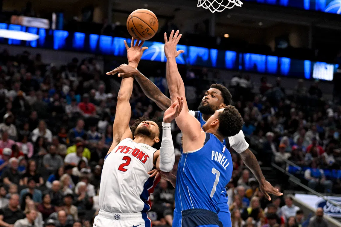 Mar 21, 2025; Dallas, Texas, USA; Detroit Pistons guard Cade Cunningham (2) shoots the ball past Dallas Mavericks forward Naji Marshall (13) and center Dwight Powell (7) during the second half at the American Airlines Center. Mandatory Credit: Jerome Miron-Imagn Images