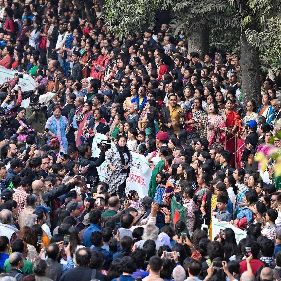 People take part in a protest organised by cultural organisation Chhayanaut against arson and vandalism of cultural institutions in Dhaka on December 23, 2025. The killing of popular student leader Sharif Osman Hadi in Dhaka set off protests on December 18 as angry mobs torched several buildings, including two major newspapers Prothom Alo and the Daily Star deemed to favour India as well as a prominent cultural institution. (Photo by Munir UZ ZAMAN / AFP)
