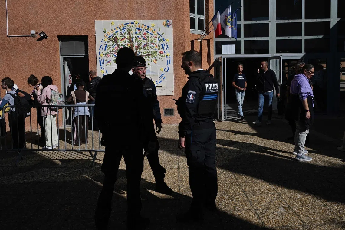 Policemen at Joseph Lakanal college in Aubagne, southern France, after a shooting incident on Oct 12.