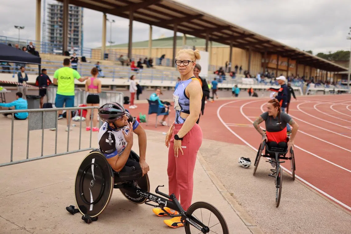 FILE PHOTO: Spanish Paralympic athlete Adiaratou Iglesias, 25, known as \"Adi\", talks with Spanish Paralympian Jose Manuel Quintero, before the International Para Athletics Meeting ahead of the Paris 2024 Paralympic Games, in L'Hospitalet de Llobregat, near Barcelona, Spain April 27, 2024. REUTERS/Nacho Doce/File photo