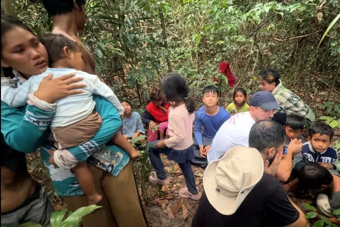 Volunteers and staff from the Cambodian Wildlife Sanctuary taking shelter in a nearby forest, after three explosions were heard nearby on 11 December 2025. 