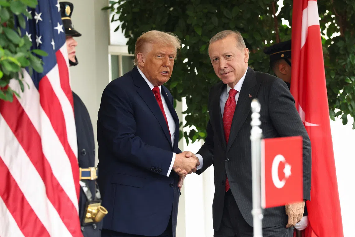 U.S. President Donald Trump and Turkey's President Recep Tayyip Erdogan shake hands as they meet at the White House in Washington, D.C., U.S., September 25, 2025. REUTERS/Kevin Lamarque