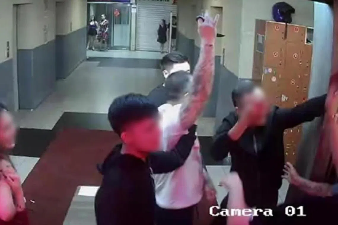 Tan Sen Yang (in white) was seen on CCTV footage holding his karambit knife.