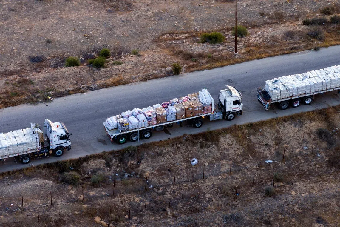 FILE PHOTO: A drone picture of part of a line of trucks waiting on an Egyptian road along the border with Israel, near the Rafah border crossing with the Gaza Strip May 2, 2024. REUTERS/Oren Alon/File Photo