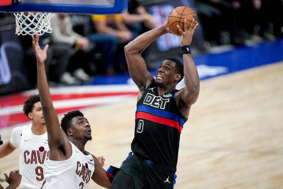 Jalen Duren of the Detroit Pistons shoots the ball against Thomas Bryant of the Cleveland Cavaliers during the fourth quarter at Little Caesars Arena.