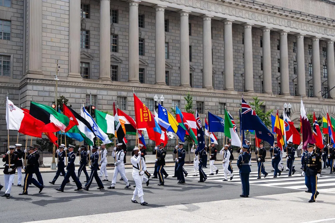 Nato member flags are carried by honor guard members during the Nato Summit outside the Andrew W. Mellon Auditorium in Washington, on July 9.
