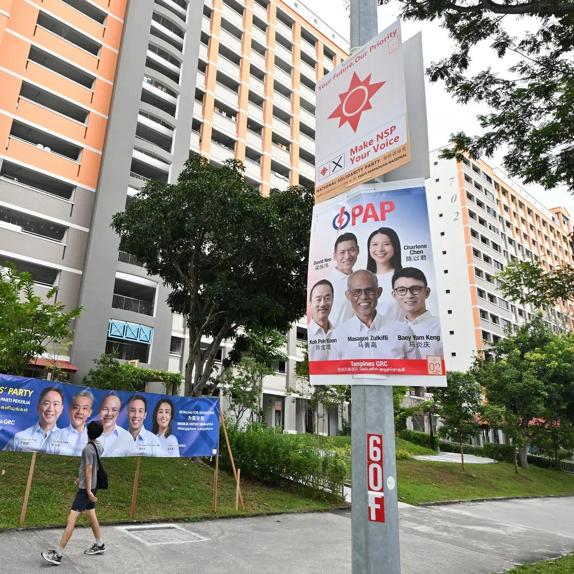 Posters of Tampines GRC candidates from Workers' Party, People's Action Party and National Solidarity Party seen near Block 701 Tampines Street 71 on April 26, 2025.