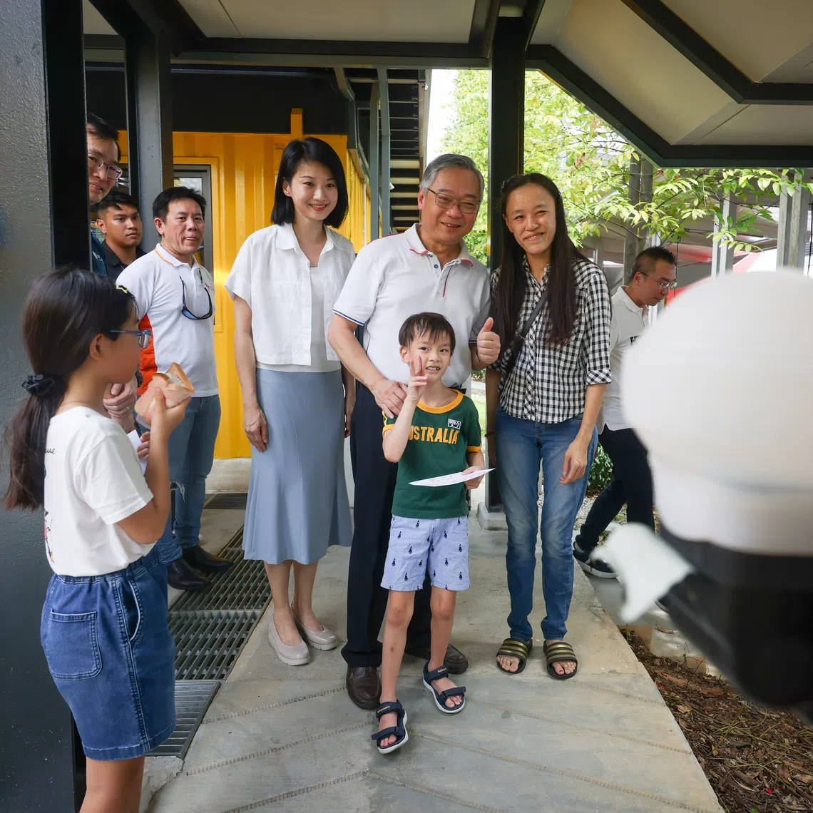 DPM Gan Kim Yong and Senior Minister of State for National Development Sun Xueling (left) with Suncare SG beneficiaries during a Children's Day event on Oct 4.