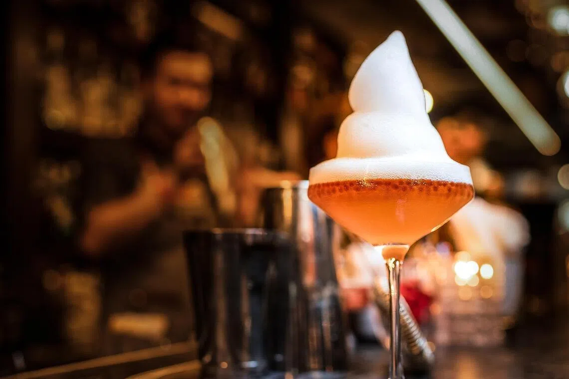 The Earl Grey Caviar Martini at Quinary is topped with foam and has spherical beads made with earl grey tea.