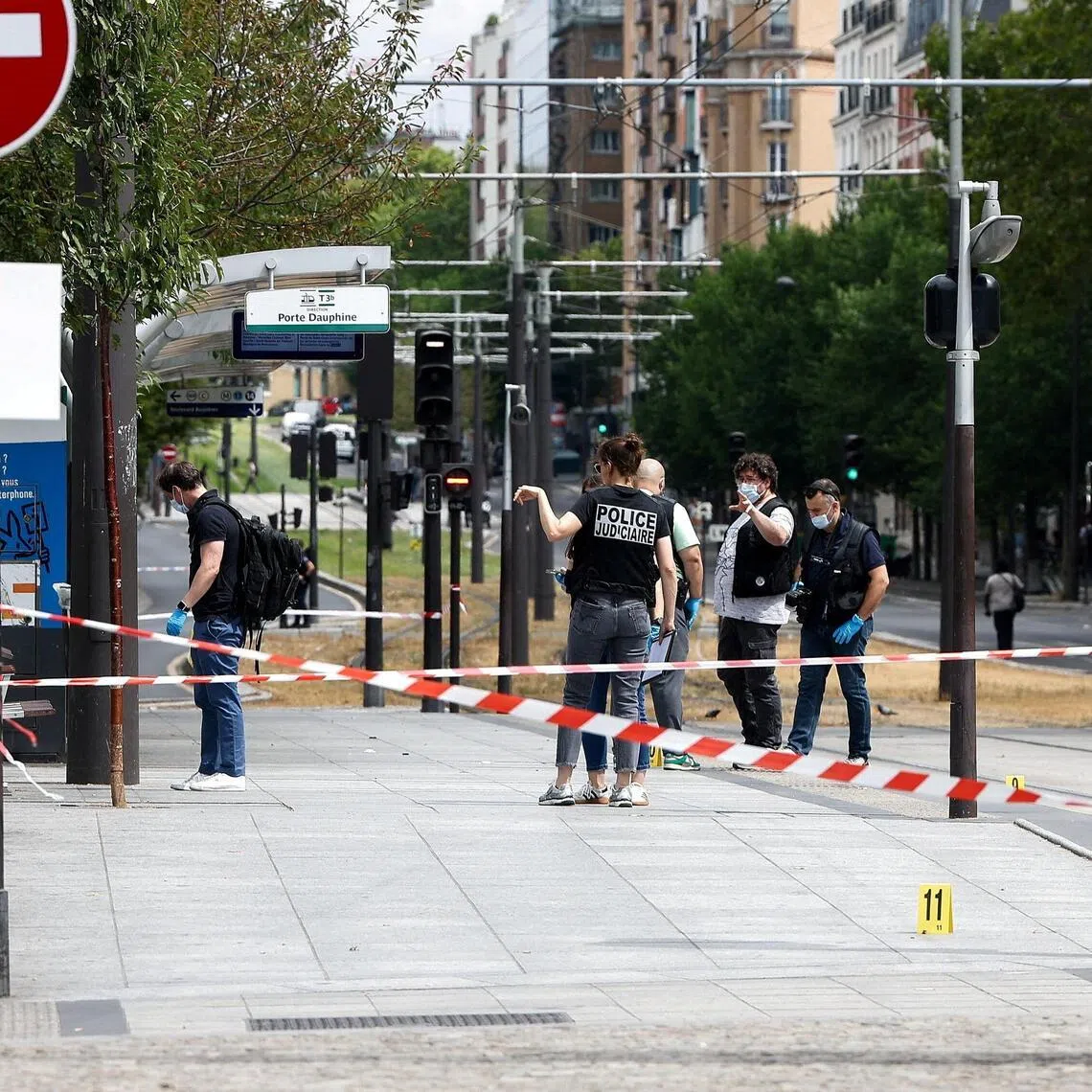 Police officers working at the site of the knife attack, in Paris’ 17th arrondissement, on July 27.