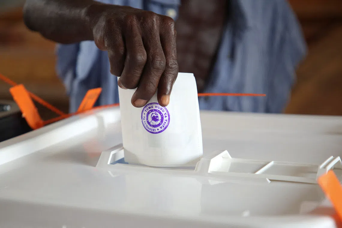 A man casts his vote during the general election at a polling station in Dar es Salaam, Tanzania, October 29, 2025. REUTERS/Emmanuel Herman