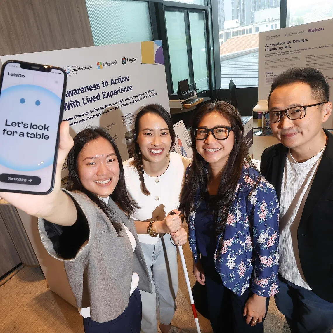 The team of four developed a prototype app to help diners with visual impairment find empty tables at hawker centres. They include product designers from Skills and Workforce Development Agency (SWDA) Tay Yu Qing and Genevieve Yip (in white), Ho Yin Mei, a principal design lead from the Ministry of Social and Family Development (MSF) and Jeffrey Ang, a principal architect from the Urban Redvelopment Authority.