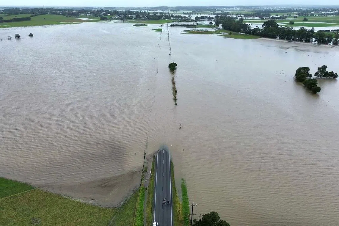 This handout photo taken and released on May 21 by the New South Wales State Emergency Service (NSWSES) shows an aerial view of High Street in Wallalong, inundated after heavy overnight rainfall across the NSW mid-north coast.