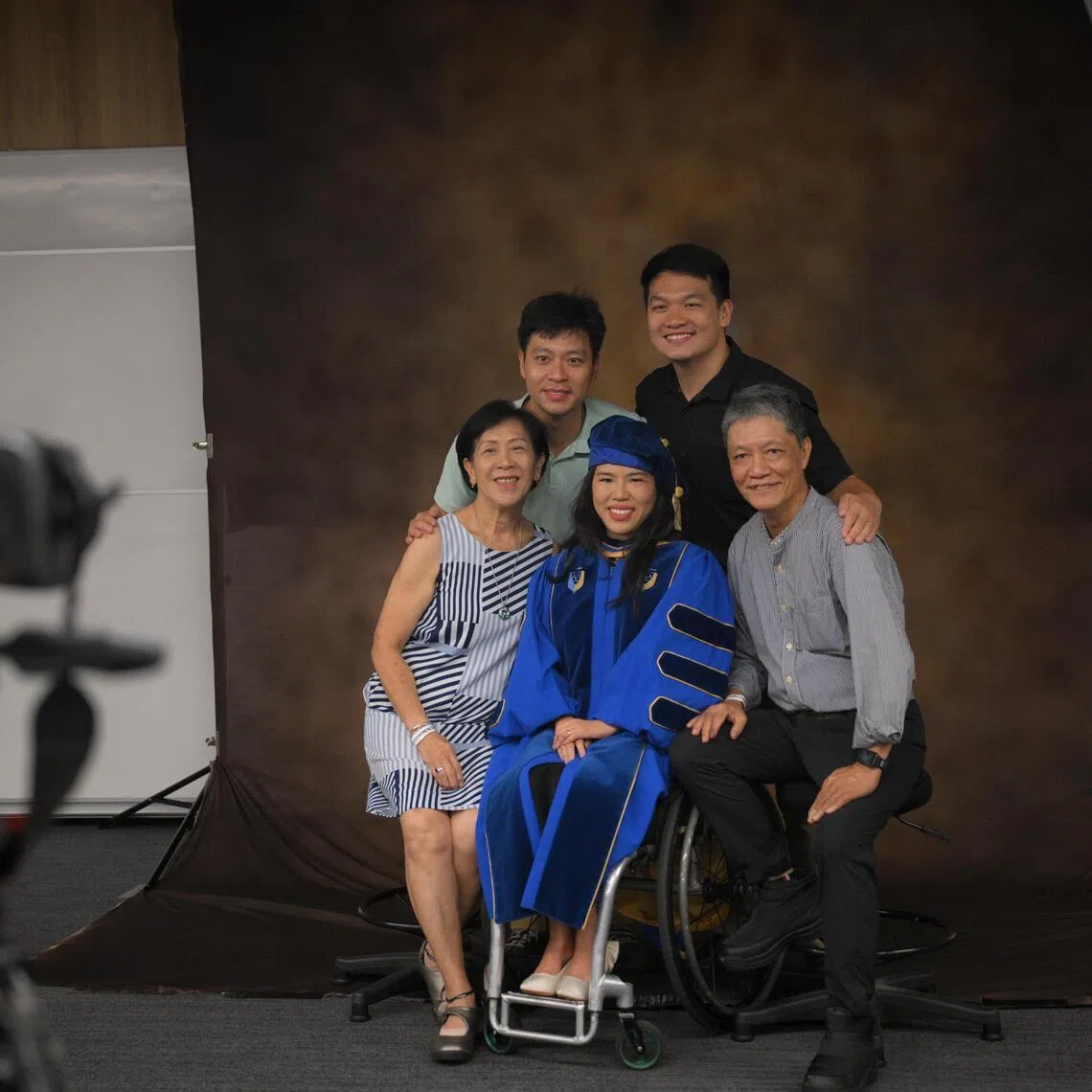 Yip Pin Xiu (centre), her parents Yip Chee Khiong and Margaret Chong (both seated), her brother Augustus Yip (left) and husband Bruce Boo, take a family picture after she recieved her Honorary Doctor of Laws degree at SMU on July 28.