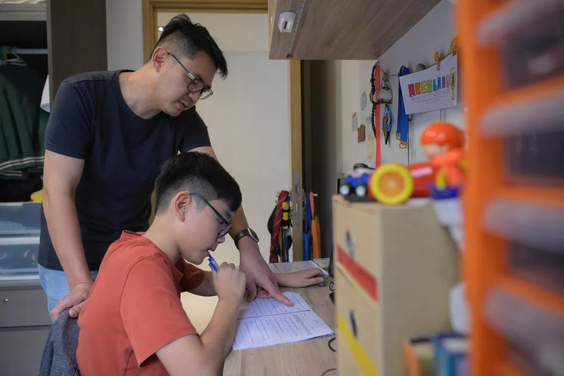 Elvin Foong sometimes accompanies his 12-year-old son Nathan while he studies for his exams at home.