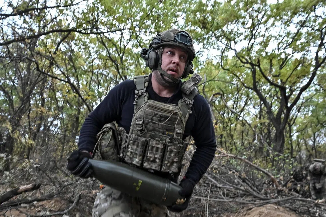 A Ukrainian serviceman preparing to fire a howitzer towards Russian troops, near the front-line city of Toretsk, Ukraine, in October 2024.