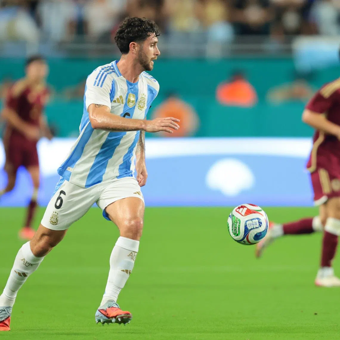 Oct 10, 2025; Miami Gardens, Florida, USA; Argentina defender Marcos Senesi (6) dribbles the ball against Venezuela during the first half at Hard Rock Stadium. Mandatory Credit: Sam Navarro-Imagn Images