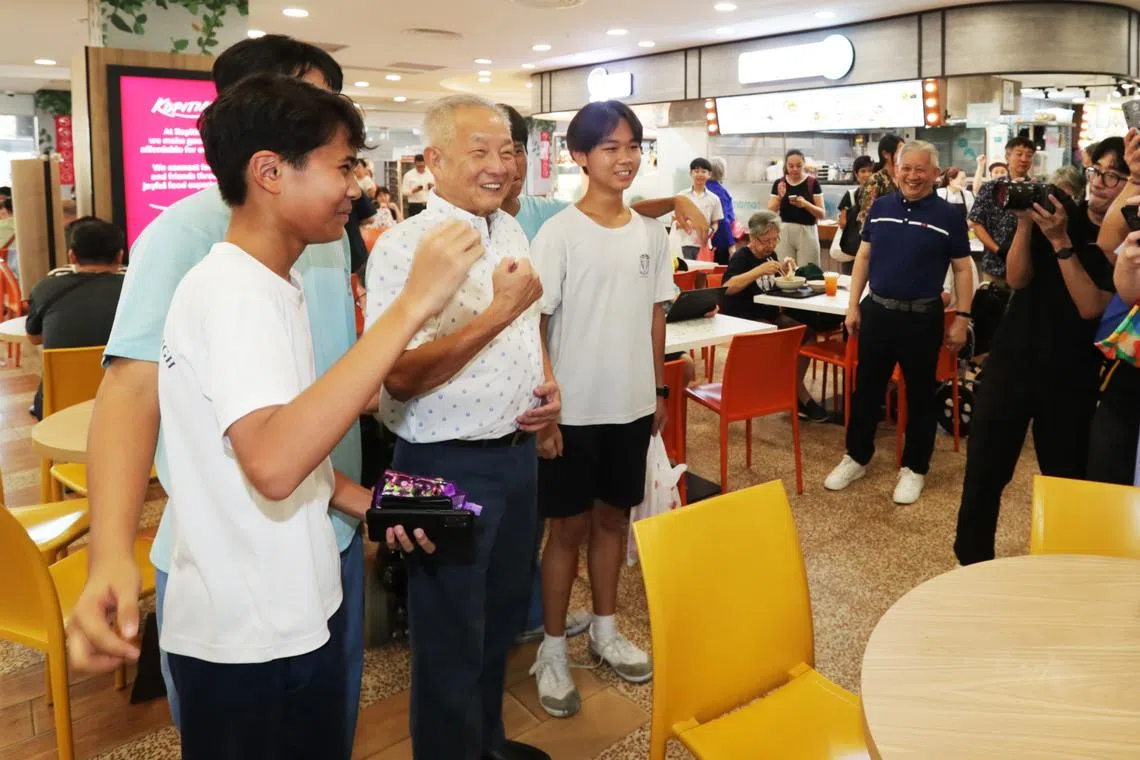 Presidential candidate Ng Kok Song posing for photos during his walkabout at Kang Kar Mall on Aug 22.