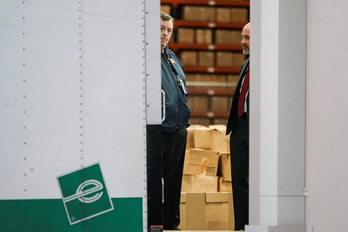 FILE PHOTO: Members of the Federal Bureau of Investigation (FBI) stand inside a vehicle loaded with boxes outside the Fulton County Election Hub and Operation Center after the FBI executed a search warrant there in relation to the 2020 election, according to a law enforcement official familiar with the matter, in Union City, Georgia, U.S. January 28, 2026.  REUTERS/Elijah Nouvelage/File Photo