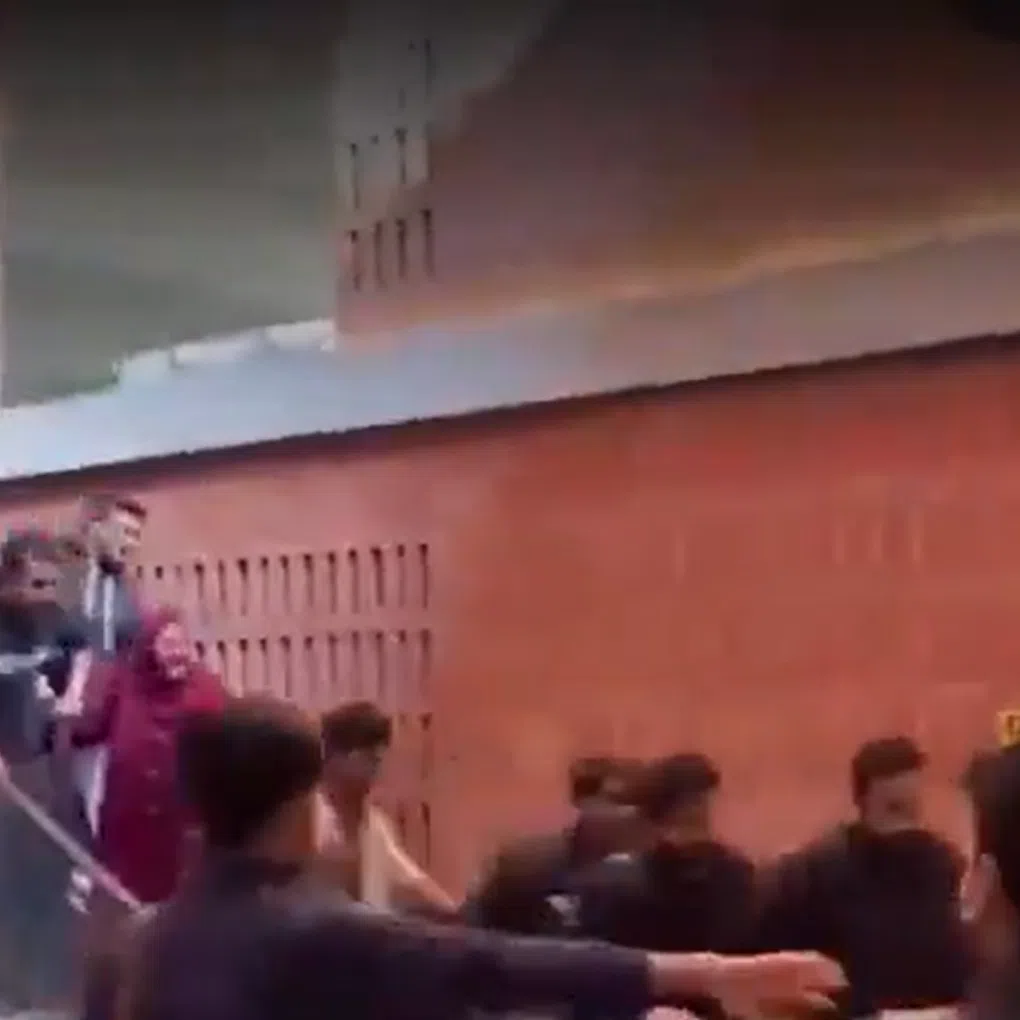 A screengrab shows students at BRAC University in Dhaka stumbling and grasping at the handrails of an escalator that suddenly surged forward.