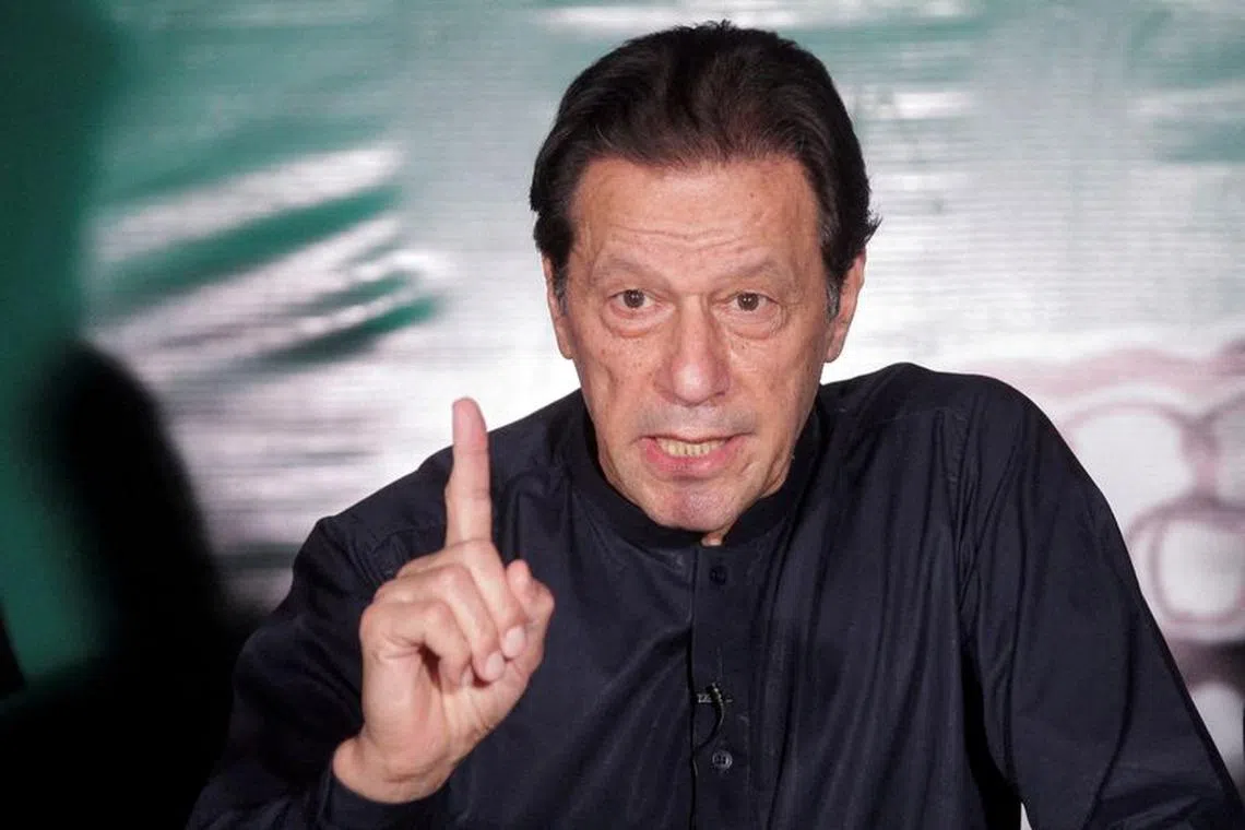 FILE PHOTO: Pakistan's former Prime Minister Imran Khan gestures as he speaks to the members of the media at his residence in Lahore, Pakistan May 18, 2023. REUTERS/Mohsin Raza/File Photo
