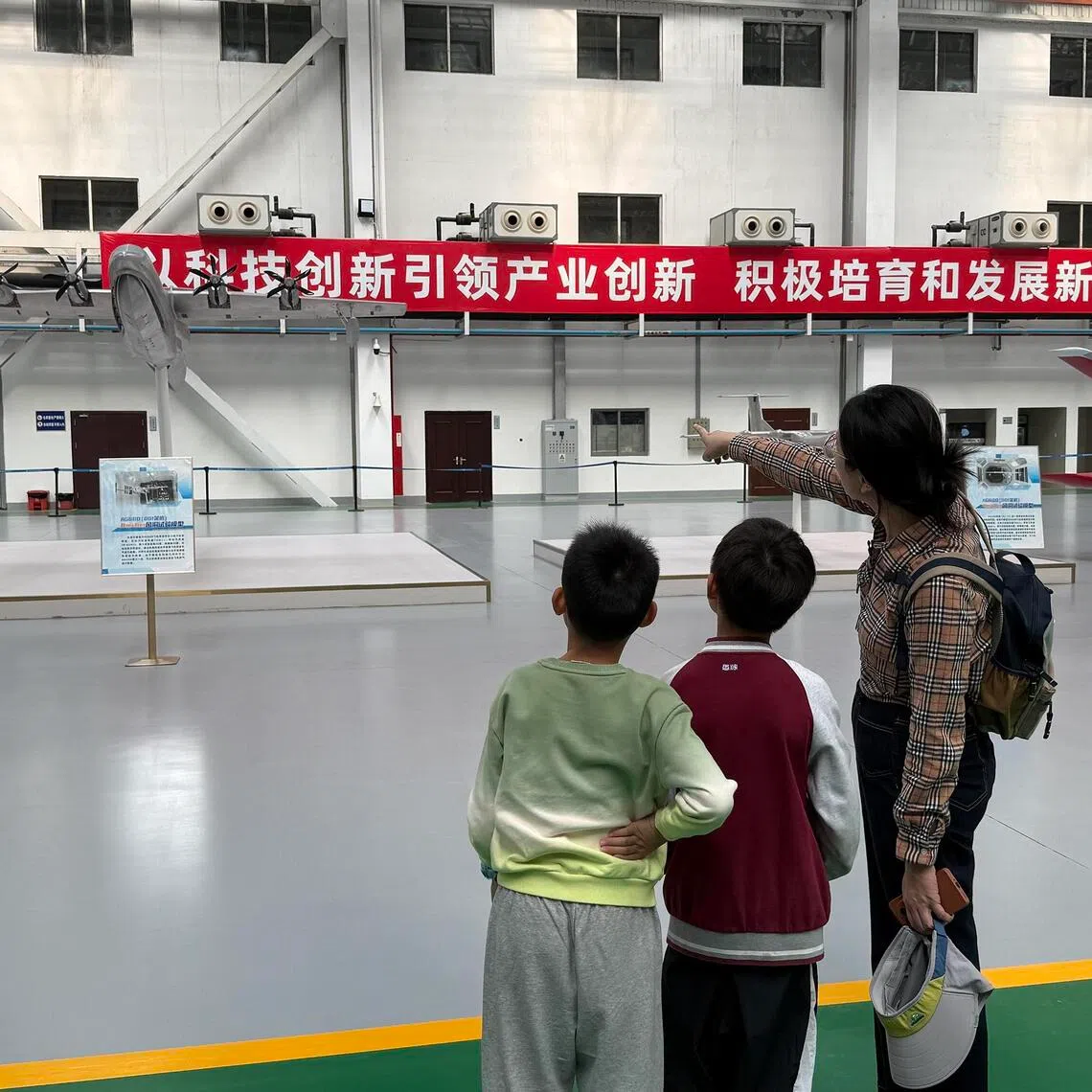 Parents and children on an airplane factory tour in Zhuhai in December 2025. 
