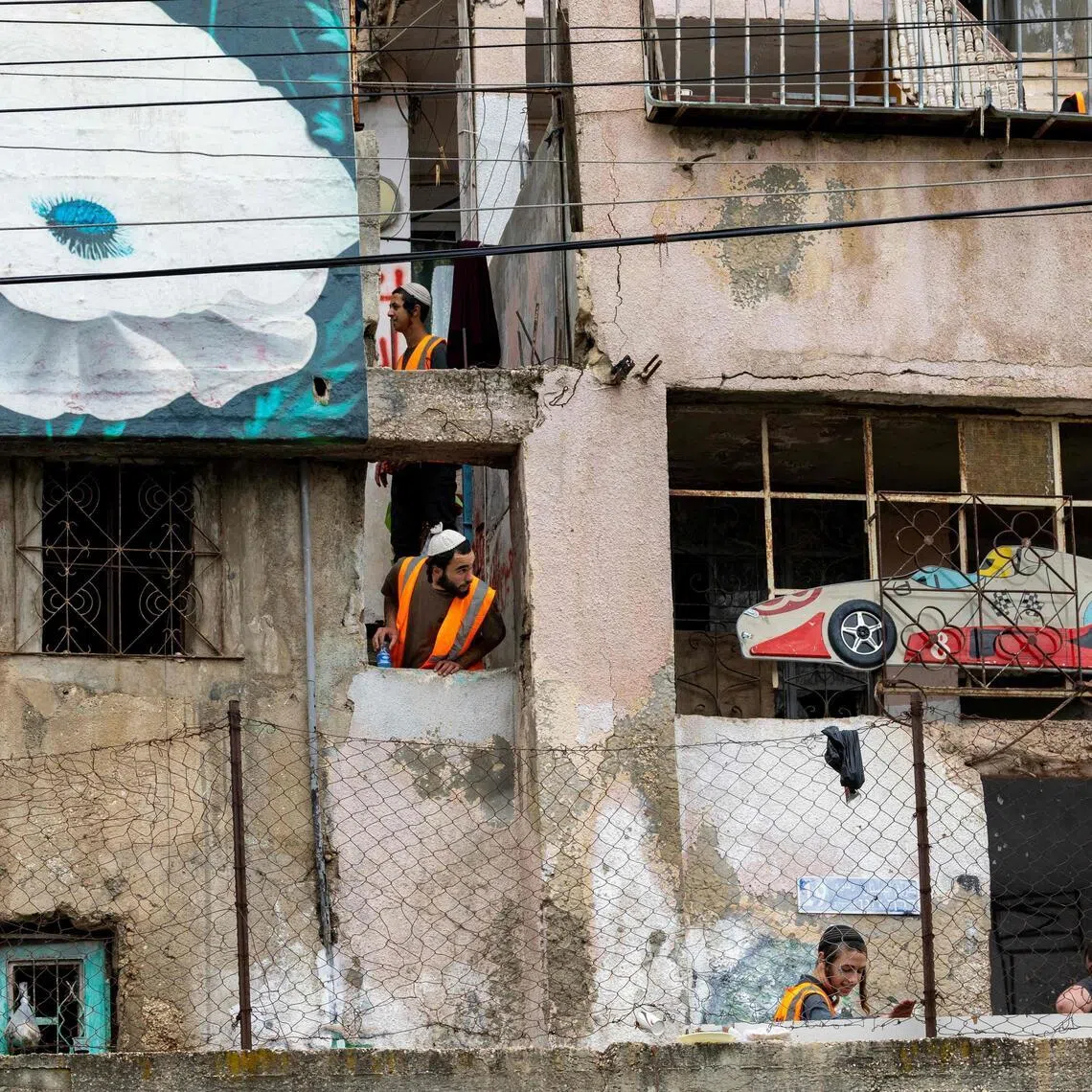 Israeli authority employees empty a Palestinian home as 11 Palestinian families in the Batan al-Hawa area of Silwan are evicted to make room for Israeli settlers.