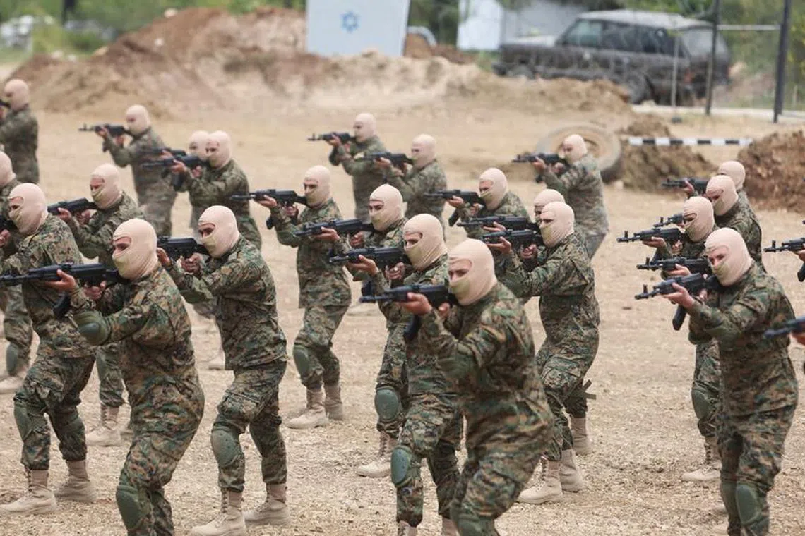 FILE PHOTO: Hezbollah members take part in a military exercise during a media tour organized for the occasion of Resistance and Liberation Day, in Aaramta, Lebanon May 21, 2023. REUTERS/Aziz Taher/File Photo