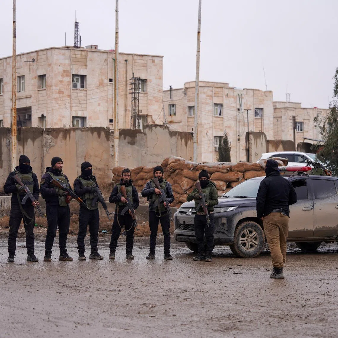 Syrian security forces stand guard outside al-Aqtan prison, where some Islamic State detainees are held, in Raqqa, Syria January 23, 2026. REUTERS/Karam al-Masri