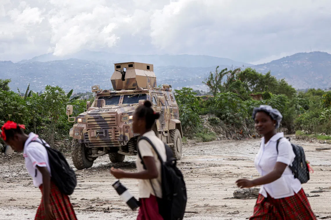 An armored personnel carrier of Haiti's UN-backed Gang Suppression Force (GSF) patrols an area after El Salvador announced a rescue mission for four air force members in the GSF that went missing after a gang ambush, in Port-au-Prince, Haiti, October 23, 2026. REUTERS/Patrice Noel