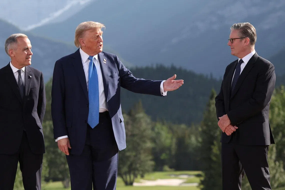 Canada's Prime Minister Mark Carney, U.S. President Donald Trump and British Prime Minister Keir Starmer attend a family photo session during the G7 Summit, in Kananaskis, Alberta, Canada, June 16, 2025. REUTERS/Suzanne Plunkett/Pool