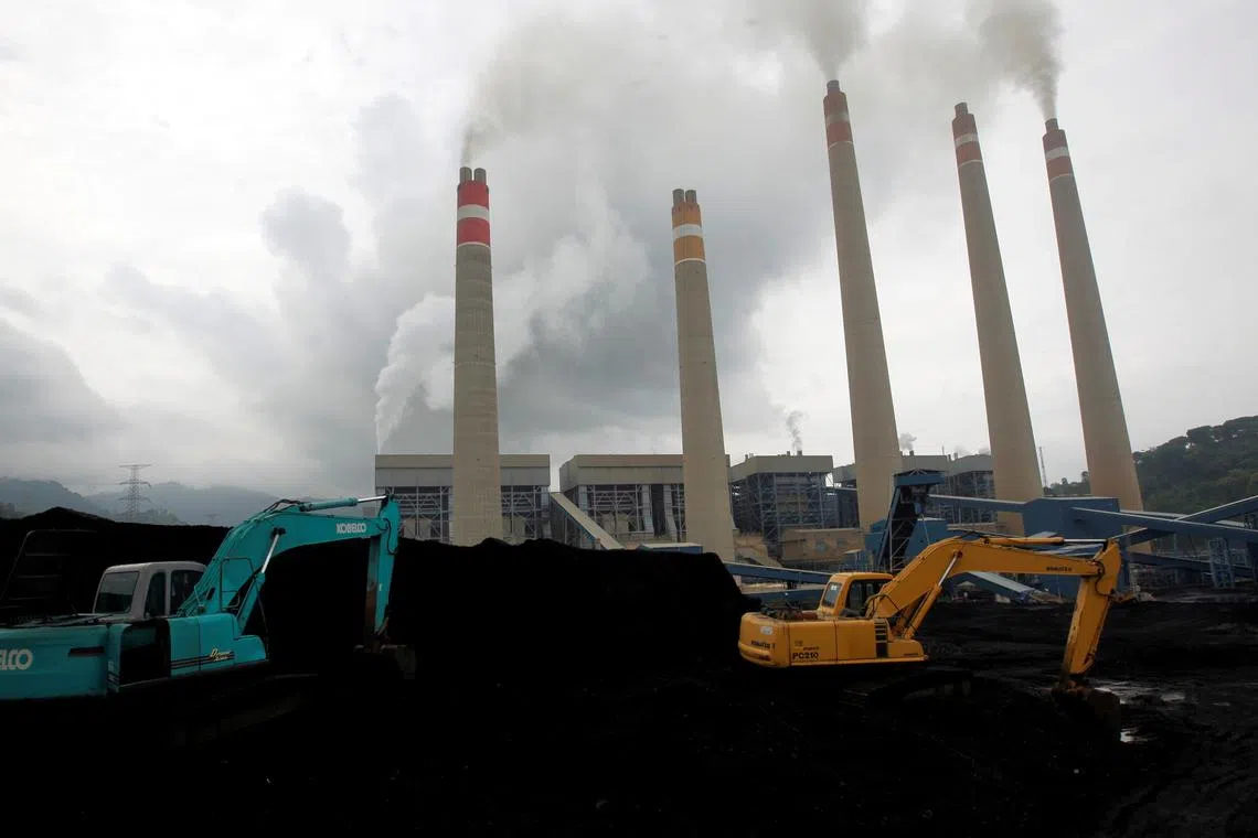 FILE PHOTO: FILE PHOTO: Excavators pile coal in a storage area in an Indonesian Power Plant in Suralaya, in Banten province January 20, 2010./File Photo/File Photo