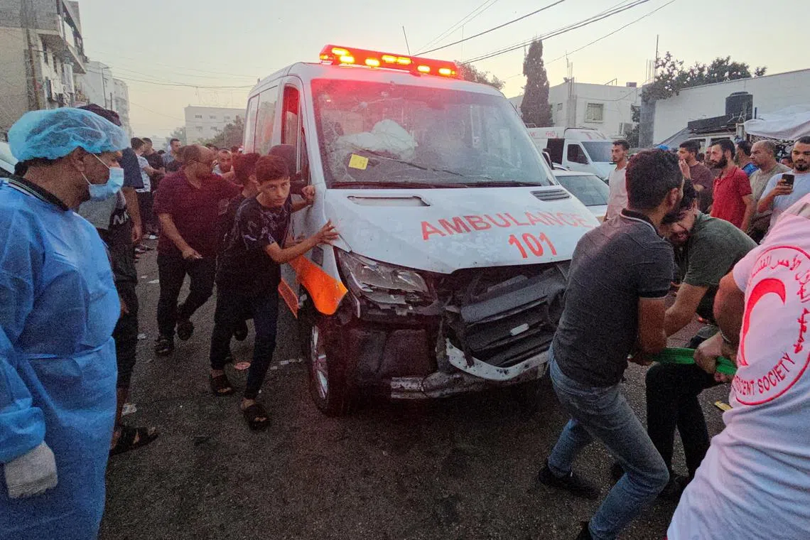 Palestinians pull an ambulance after a convoy of ambulances was hit in Gaza City.