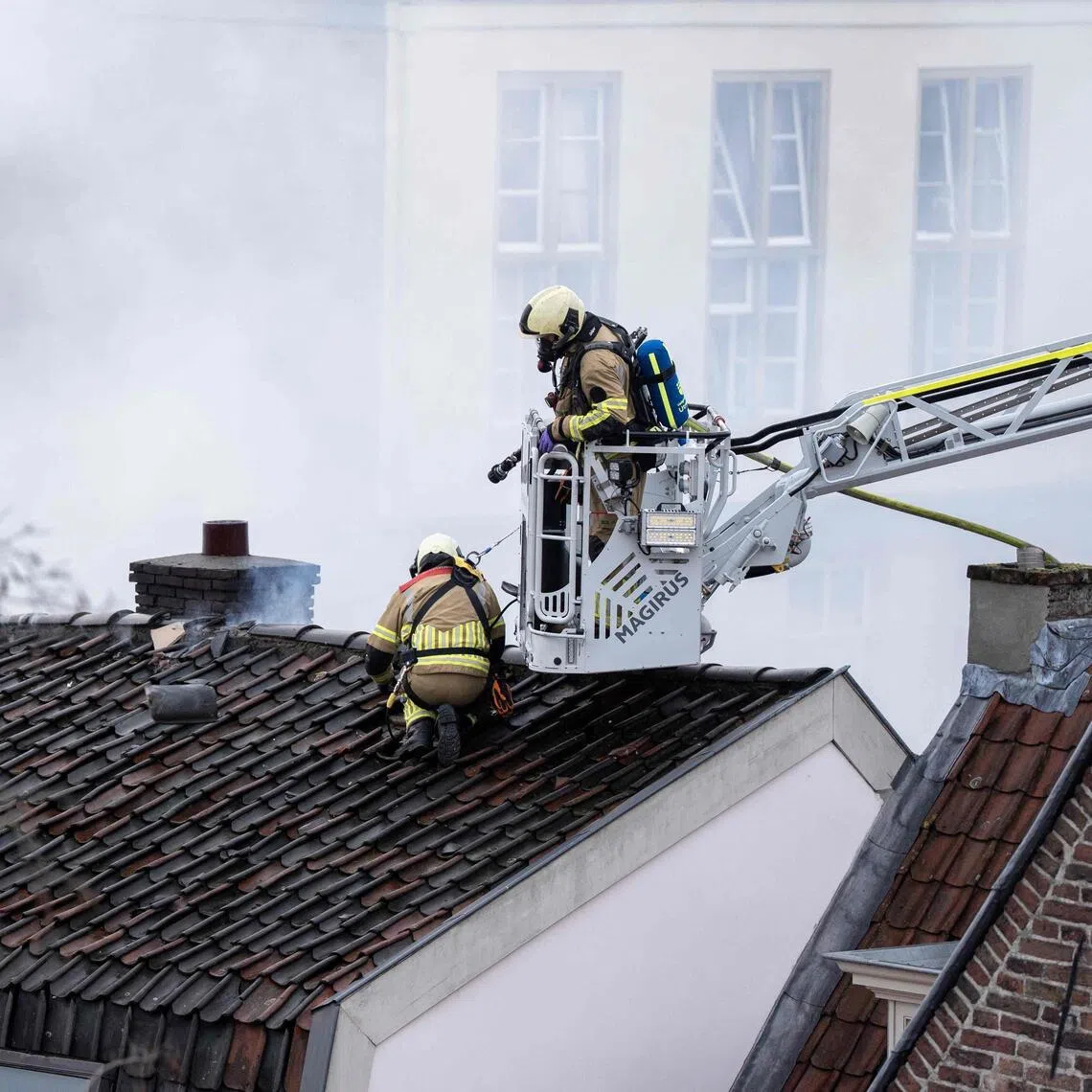 Firefighters working to extinguish a large fire at a residential house in Visscherssteeg, Utrecht, on Jan 15.