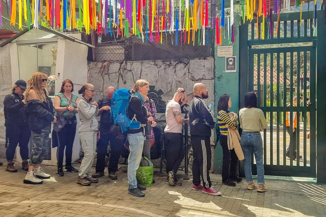 Stranded tourists queue at the train terminal in the town of Machu Picchu, Peru’s main tourist attraction, after service was suspended, on Dec 14, 2022.
