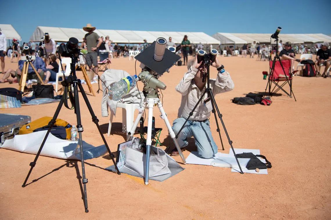 Stargazers parked their caravans, pitched telescopes and donned protective glasses to watch the moon seemingly creep across the sun’s surface before the totality.