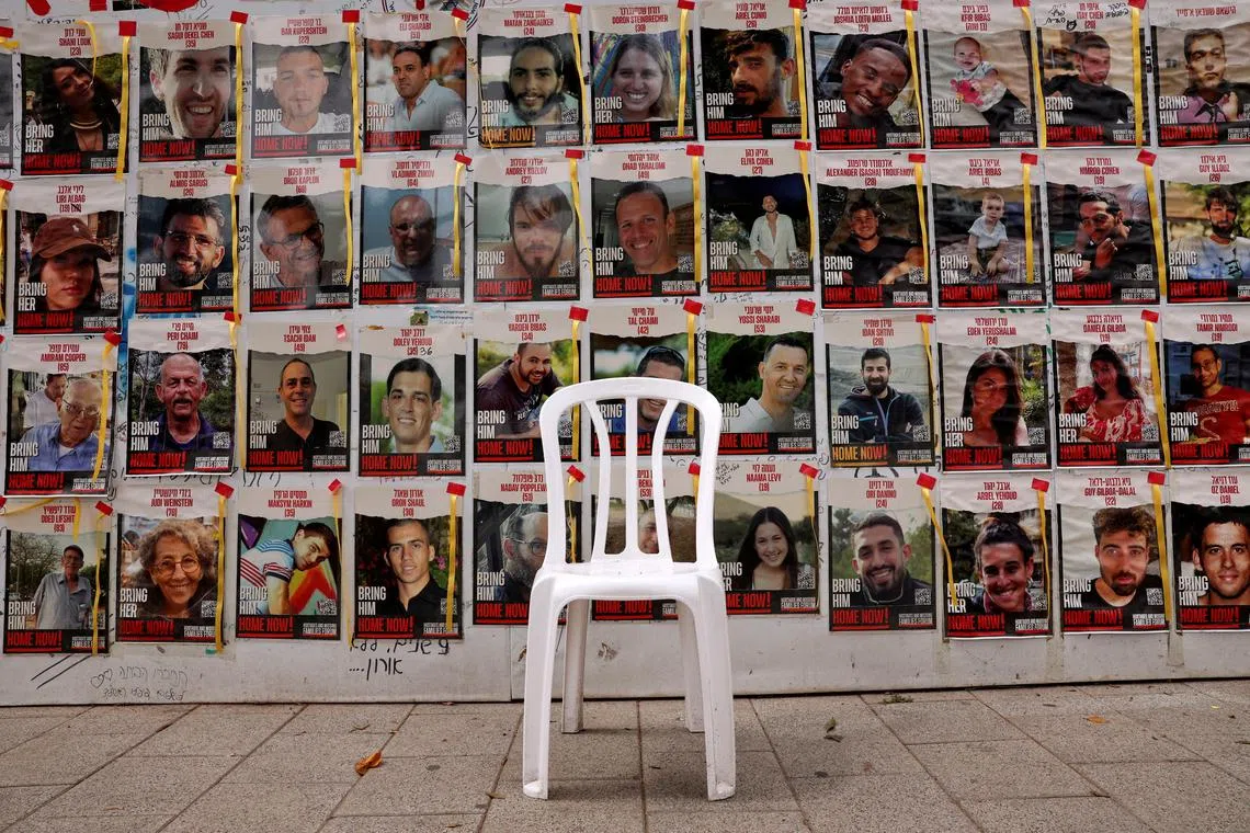 A chair is left in front of posters with pictures of hostages, who were kidnapped during the deadly October 7 attack on Israel by Palestinian Islamist group Hamas, amid the ongoing conflict in Gaza between Israel and Hamas, in Tel Aviv, Israel, April 26, 2024. REUTERS/Shannon Stapleton