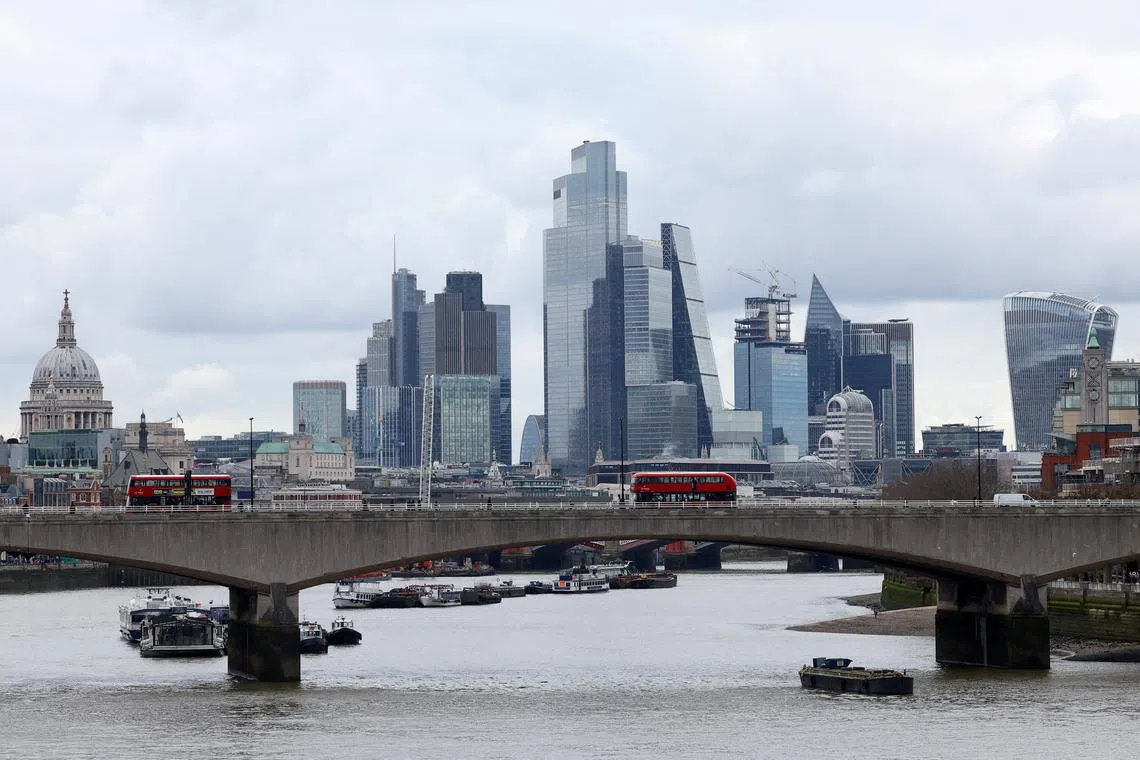 FILE PHOTO: Buses cross Waterloo Bridge with the City of London financial district seen behind, in London, Britain, March 5, 2024. REUTERS/Toby Melville/File Photo