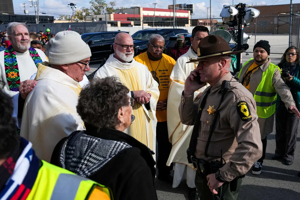 FILE PHOTO: Law enforcement officers prevent religious leaders from entering the Broadview ICE facility and offering communion to immigrants detained inside, during a Catholic Mass, led by Bishop Jose Maria Garcia Maldonado, observed by interfaith leaders, community members, and volunteers,  after U.S. President Donald Trump ordered an increased federal law enforcement presence to assist in crime prevention, in the Chicago suburb of Broadview, Illinois, U.S., November 1, 2025. REUTERS/Leah Millis/ File Photo/File Photo