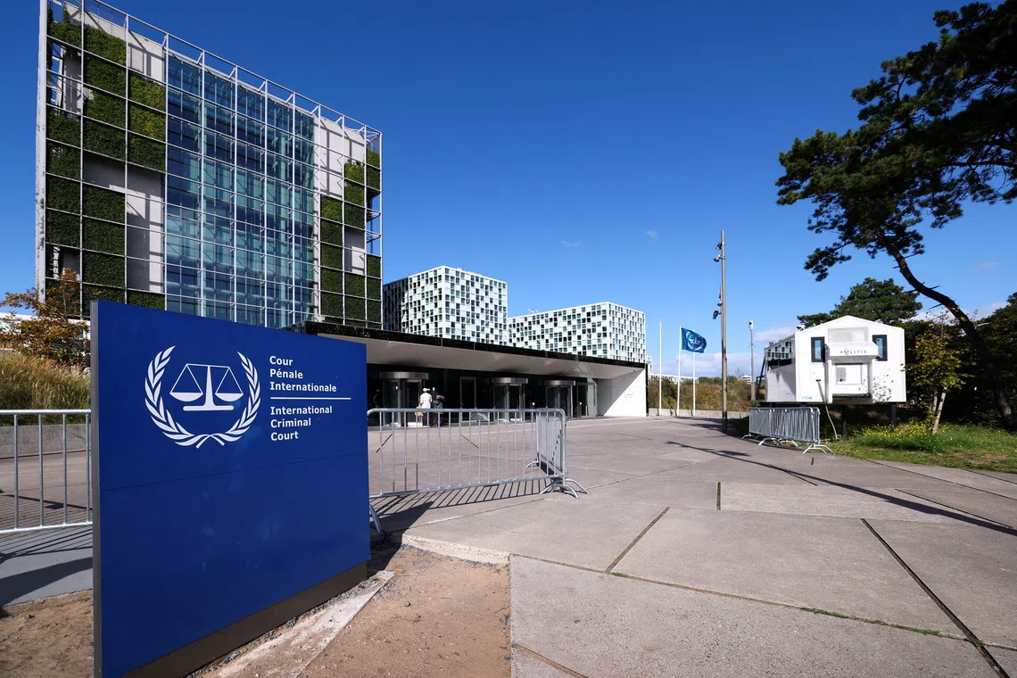 FILE PHOTO: People stand outside the International Criminal Court (ICC), in The Hague, Netherlands, September 22, 2025. REUTERS/Piroschka van de Wouw/File Photo