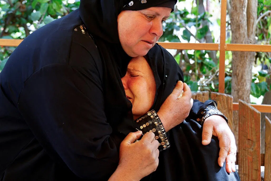 Mourners react during the funeral of two Palestinians killed by Israeli fire in Rafah, at Nasser hospital in Khan Younis, in the southern Gaza Strip, on March 3, 2025.