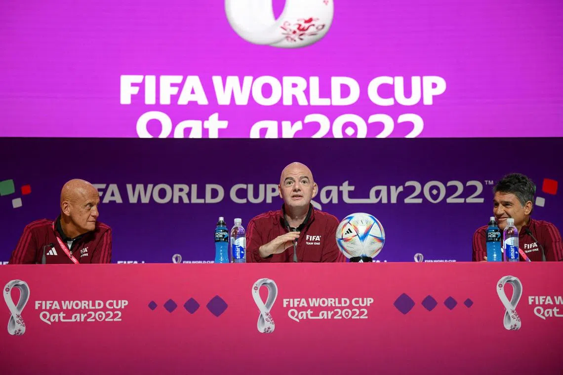 From left: Fifa referees committee chairman Pierluigi Collina, Fifa president Gianni Infantino and head of the Fifa referee department Massimo Busacca address a press conference at the Qatar National Convention Centre on Nov 18, 2022.