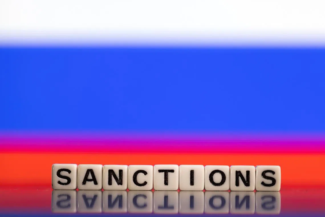 FILE PHOTO: Plastic letters arranged to read \"Sanctions\" are placed in front of Russian flag colors in this illustration taken February 25, 2022. REUTERS/Dado Ruvic/Illustration/File photo