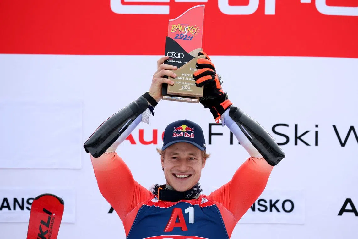 Alpine Skiing - FIS Alpine Ski World Cup - Men's Giant Slalom - Bansko, Bulgaria - February 10, 2024 Switzerland's Marco Odermatt celebrates on the podium with a trophy after winning the men's giant slalom REUTERS/Stoyan Nenov/File Photo